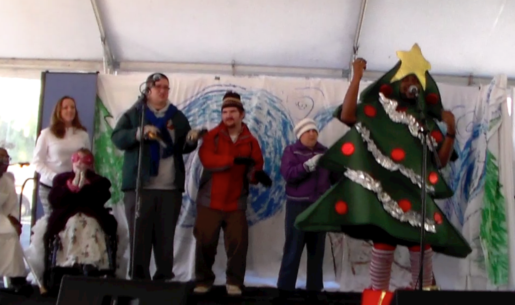 Actors with disabilities play the Great Christmas Tree, Snow Woman, Snow Angel and Pearls on stage.